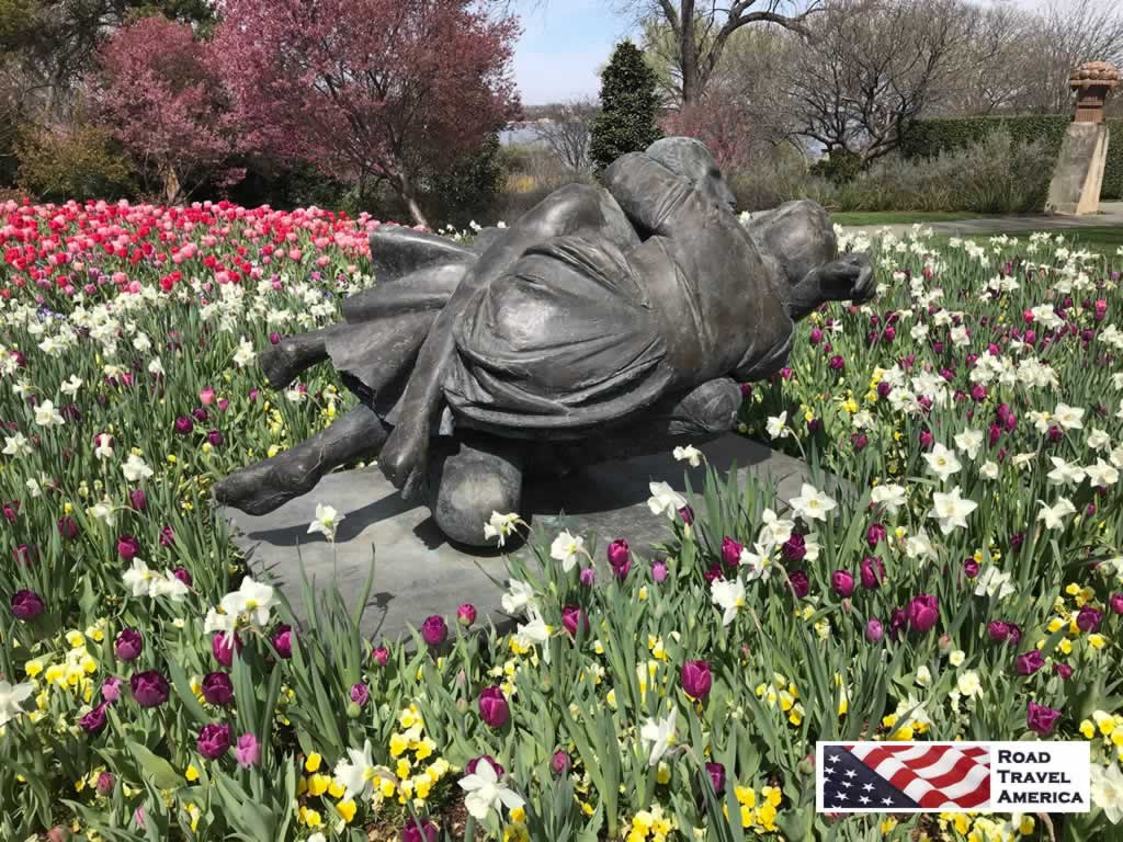 Garden sculpture amidst spring blooms at the Dallas Arboretum