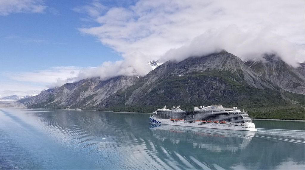 Cruise ship sailing through the smooth, blue-green waters at Glacier Bay National Park