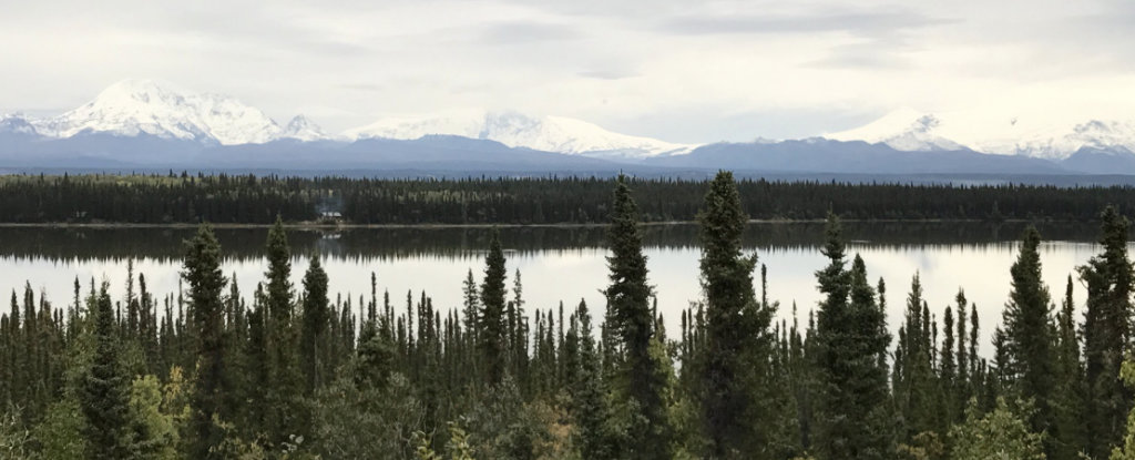 Peaceful lake with snow-capped mountains in the distance ... at Wrangell-St. Elias National Park 