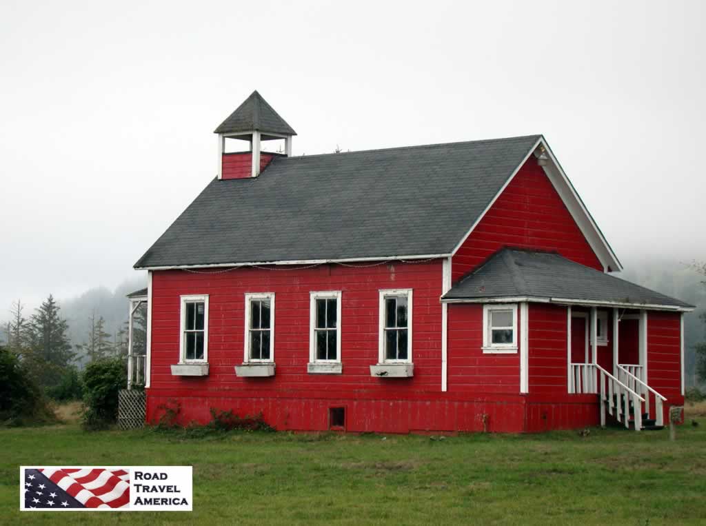The red, wooden school house on a foggy morning in California