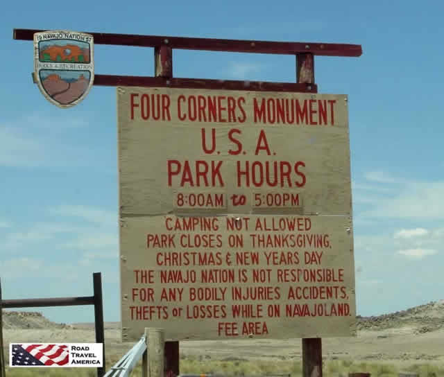 Four Corners Monument U.S.A. sign showing opening hours and restrictions