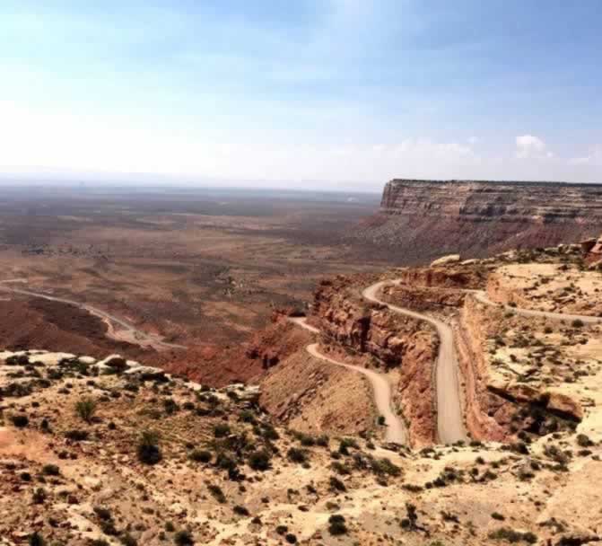 Aerial view of the Moki Dugway in Utah, seen from the top of Cedar Mesa, with the Valley of the Gods below